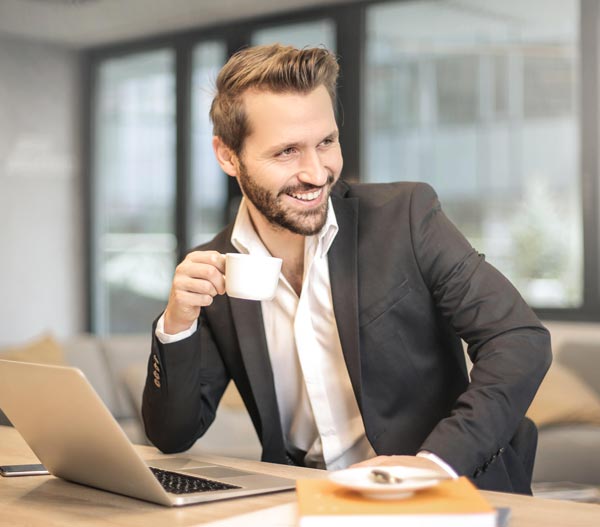 Smiling businessman with coffee