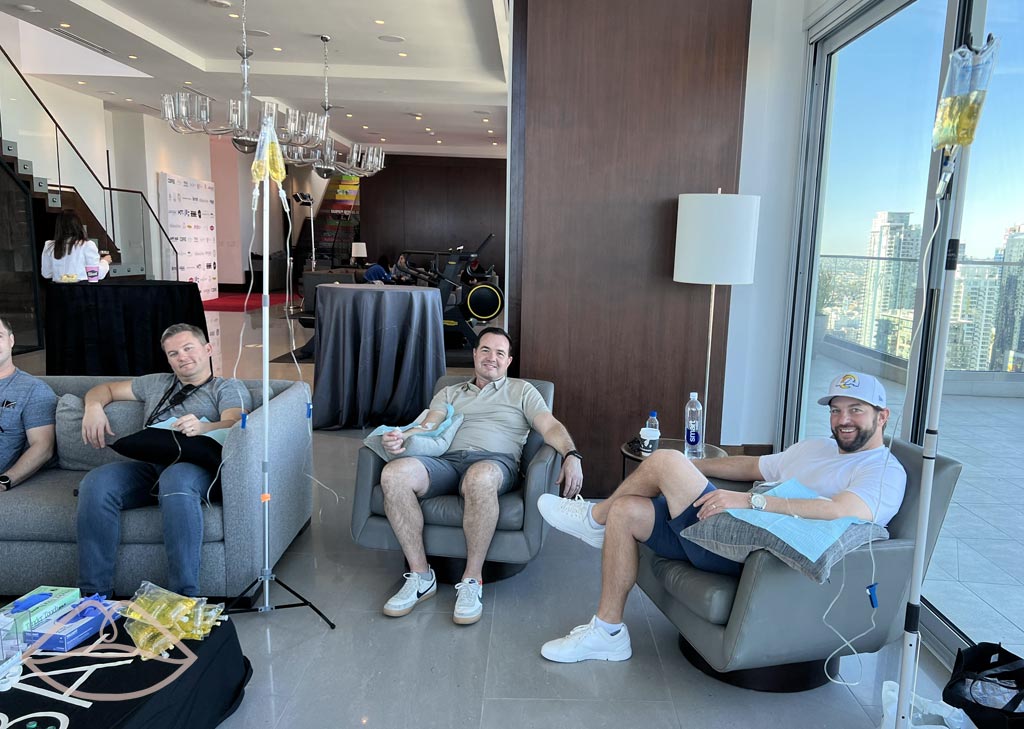 Photo of men getting IV therapy treatment together at event